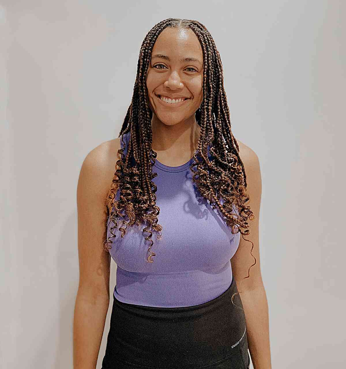 Chest-Length Brown Knotless Box Braids with Center Part and Curly Ends