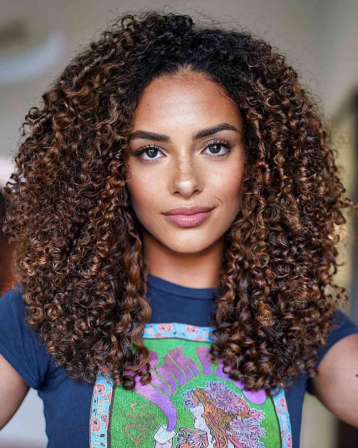 Brunette Balayage for Tight Curls on women with a large forehead and mid-length hair