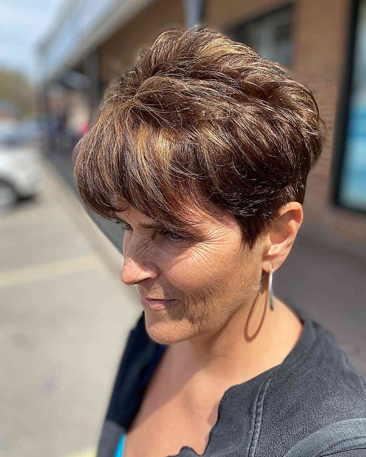 Brunette Long Pixie with Choppy Layers and Bangs for 70-Year-Old Ladies