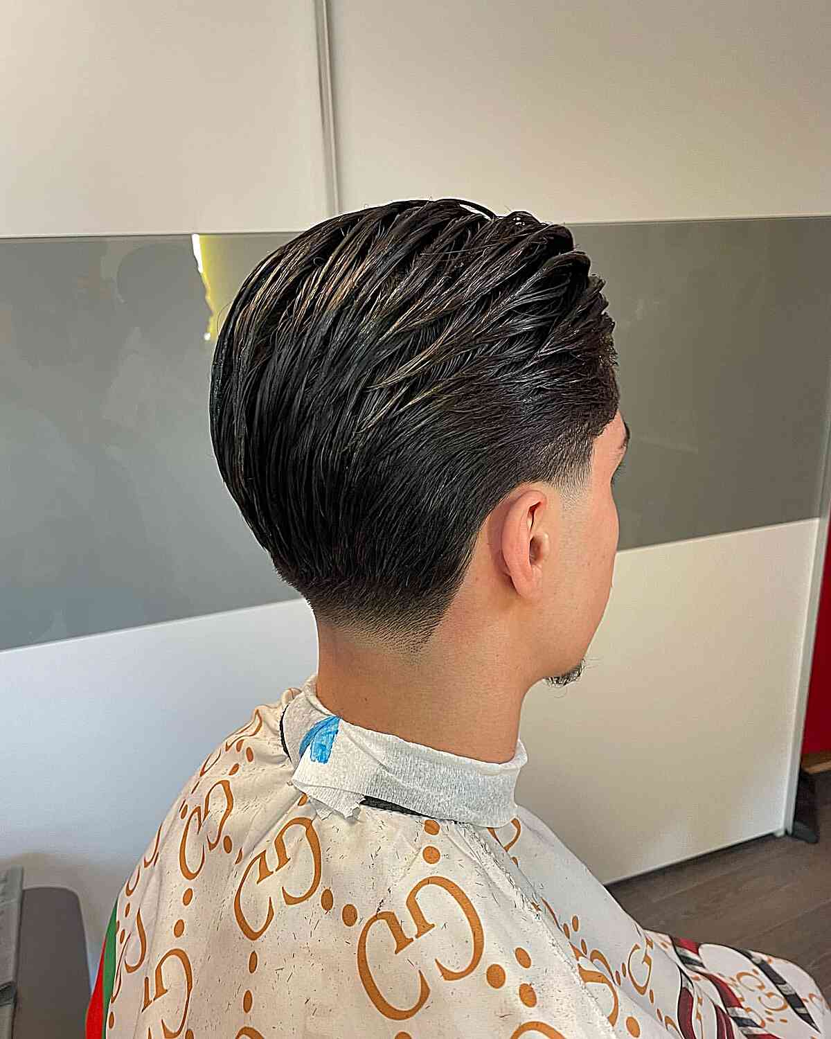 Brushed Back Wet Style with Low Taper Fade on boys with sleek hair