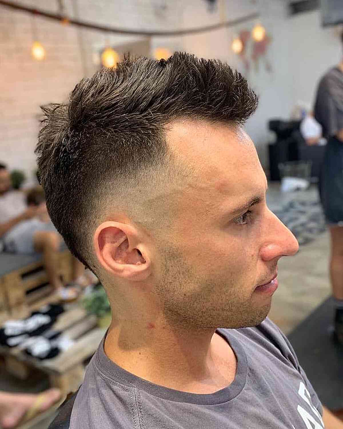 Brushed-Up Short Mohawk with Choppy Texture and Skin Fade on Men's Dark Hair