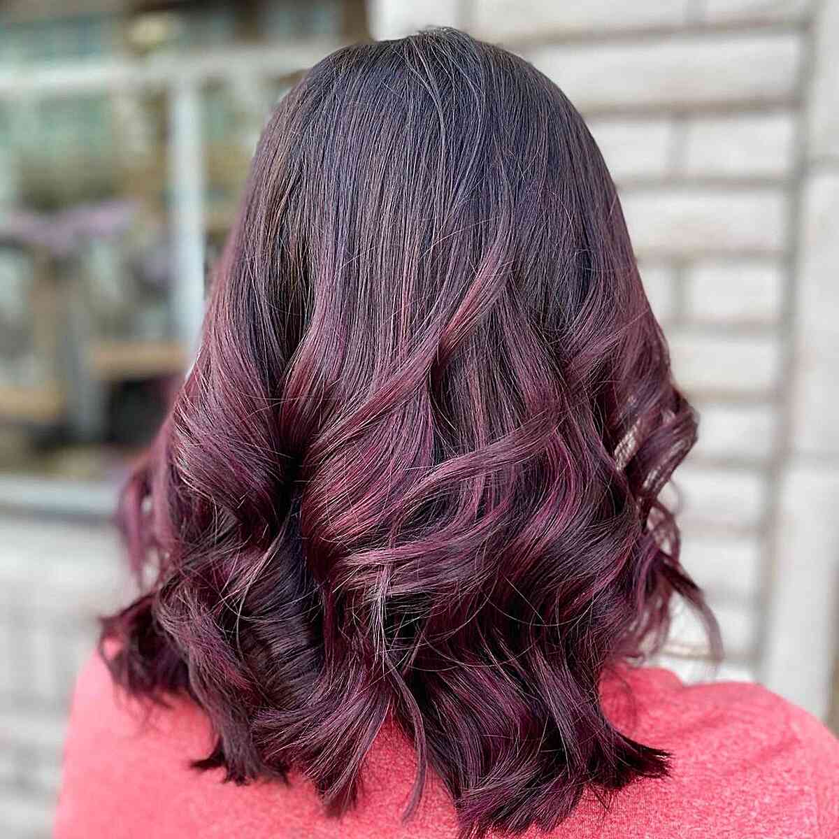 Burgundy Balayage Highlights on Shoulder-Length Cut with Thick Waves