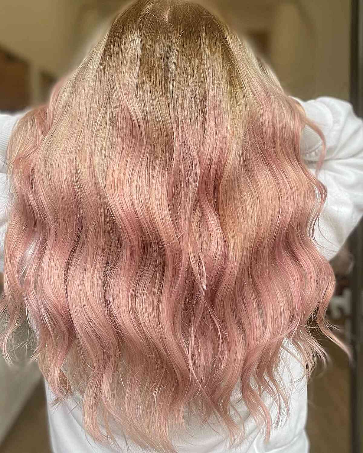 Buttery Blonde base hair color with Light Rose Gold Highlights on long hair