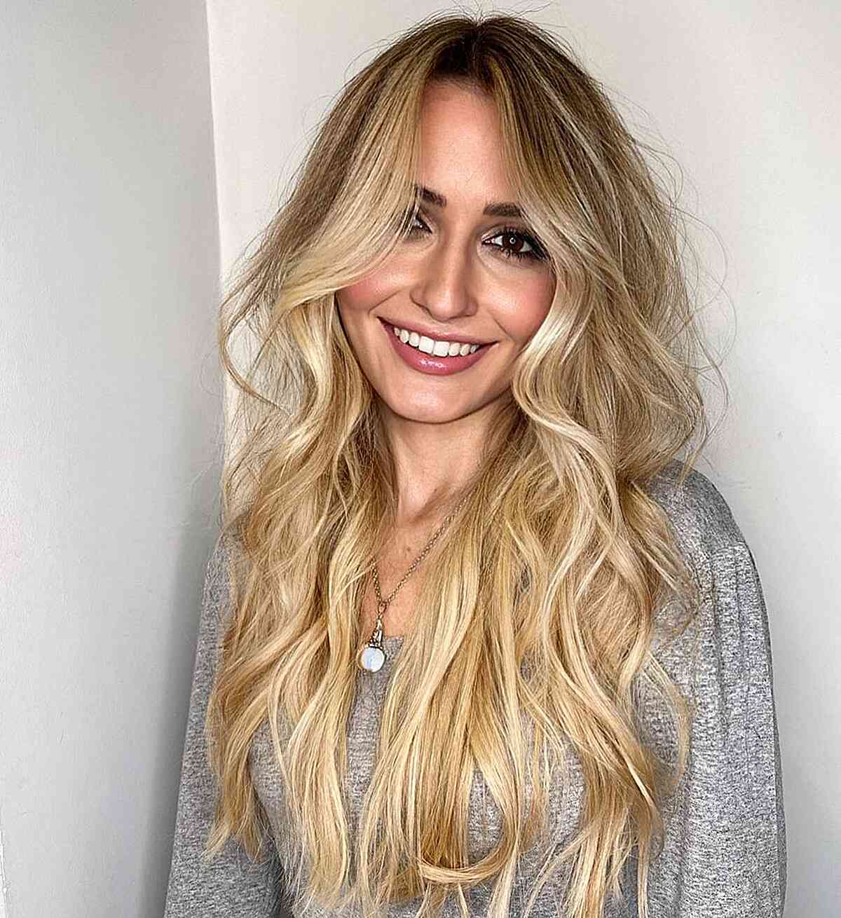 Buttery Golden Blonde Balayage with Dark Roots for Long Waves and Face-Framing Hairstyle