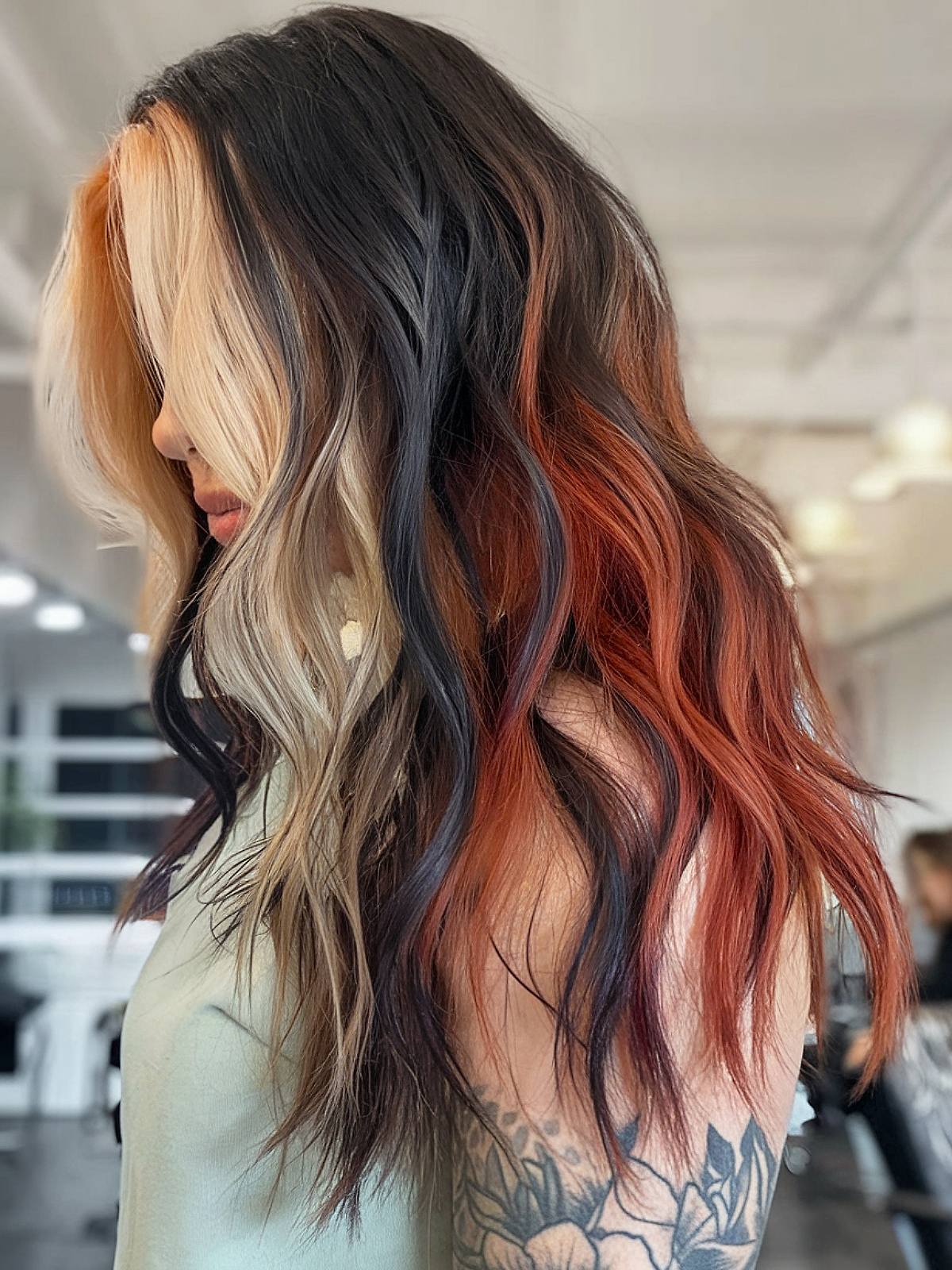 Calico cat-inspired hair color with black, orange, and blonde streaks