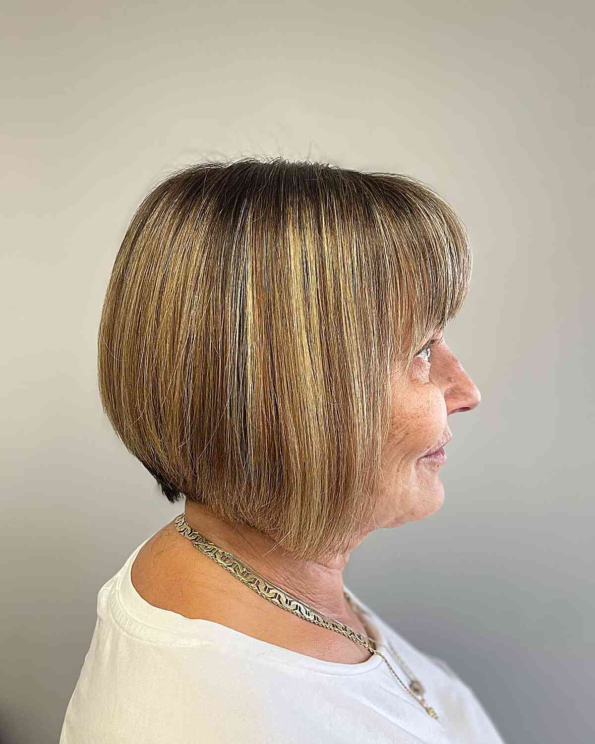 Caramel Balayage on a Short Bob with Bangs for Ladies Over 60