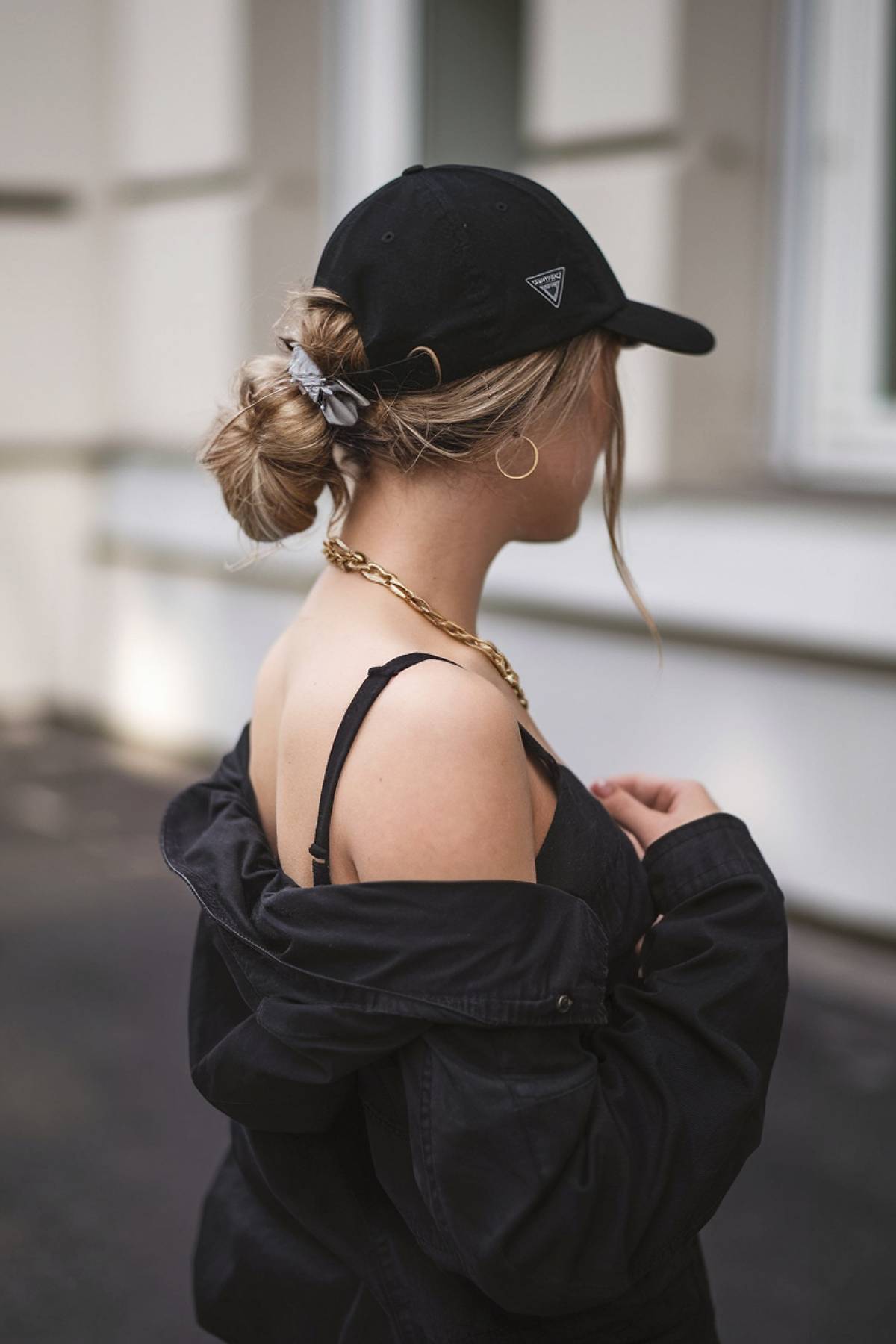 Low messy bun with baseball cap