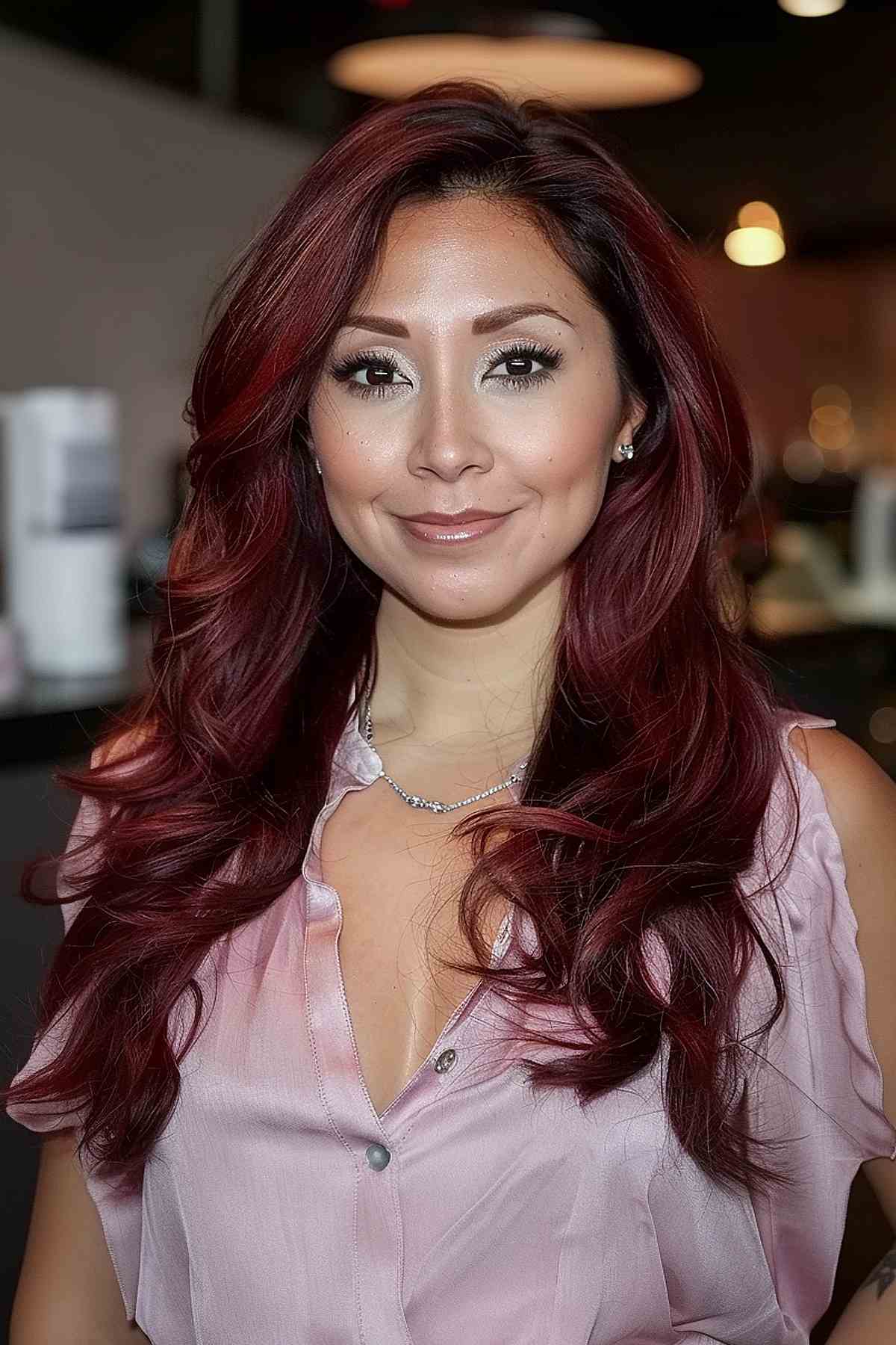 Long wavy cherry cola hair, ideal for olive skin tones.