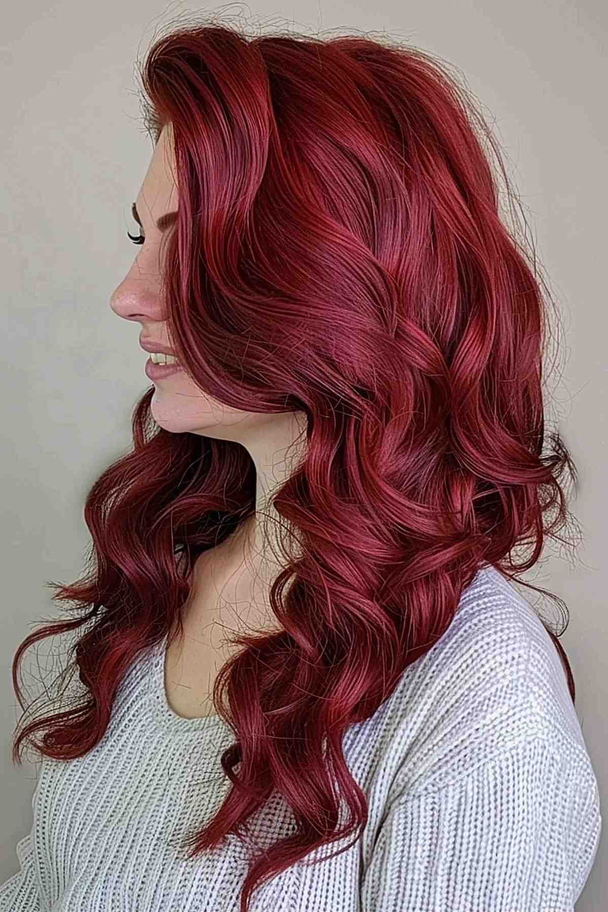 Vibrant cherry red hair with naturally curly ends, ideal for thick hair.