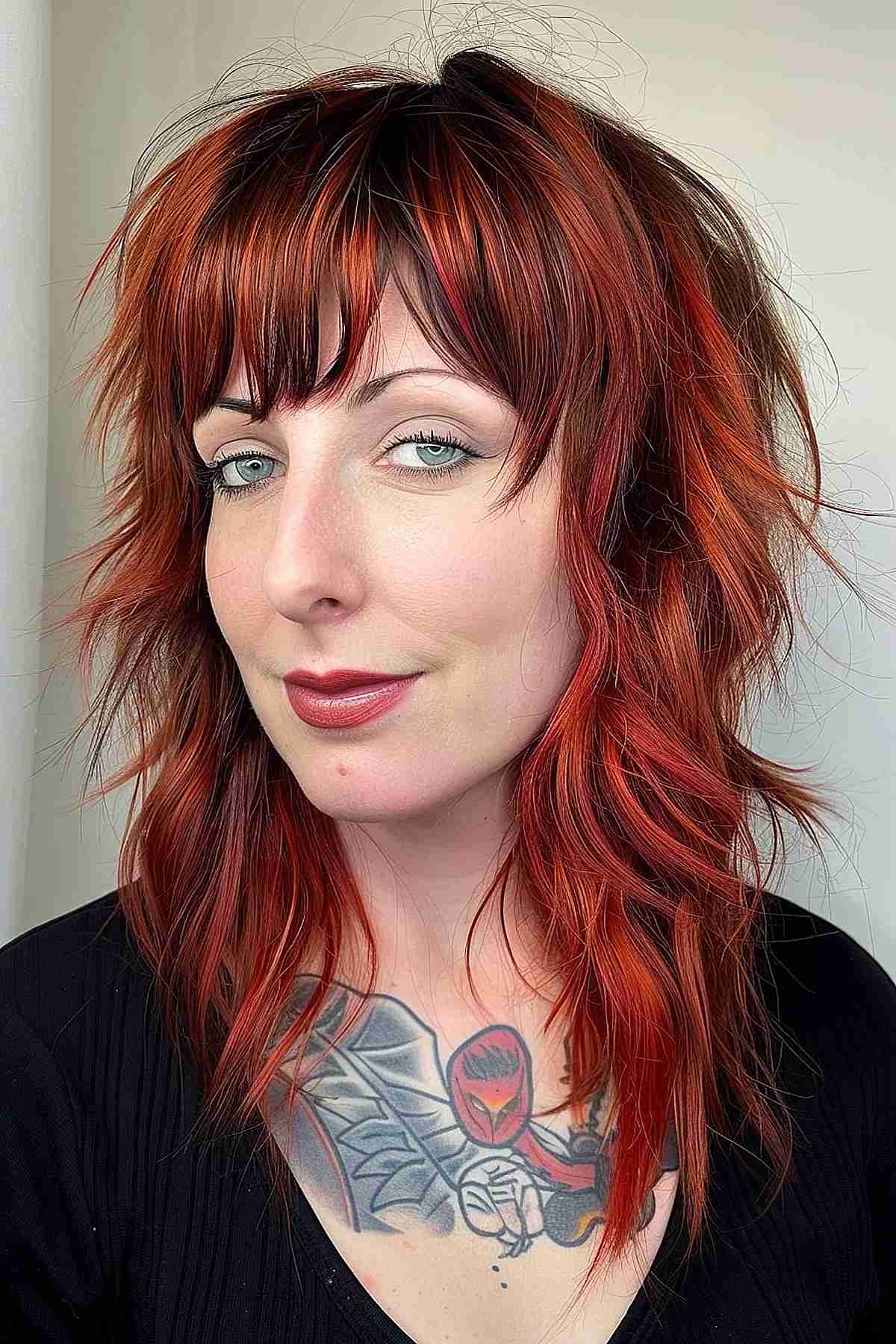 Cherry red wolf cut hairstyle, adding volume and texture to the hair.