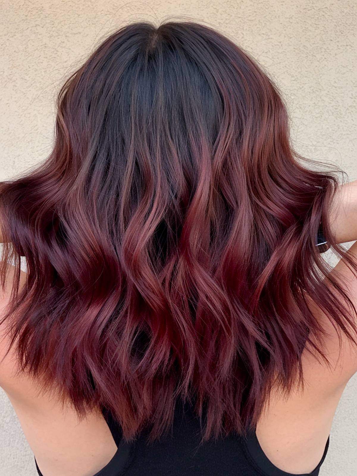 Cherry wine with highlights on long hair