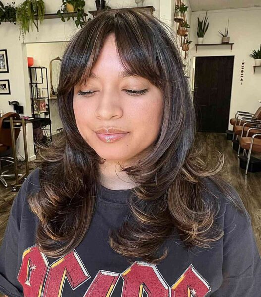 A Chest-length Layered Cut and Long Curtain Fringe for Round Faces