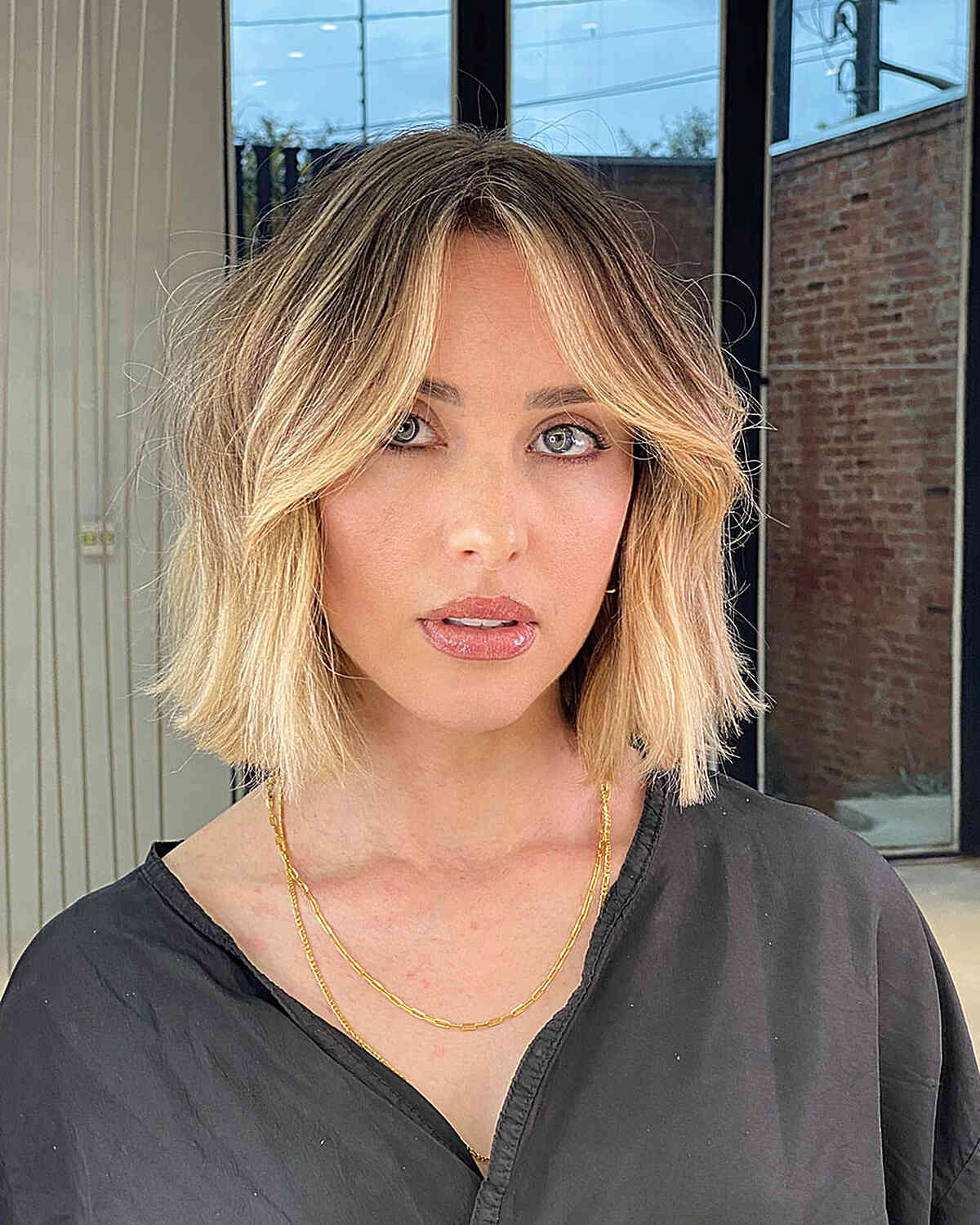 Chic Blunt Bob with Curtain Bangs and dark roots