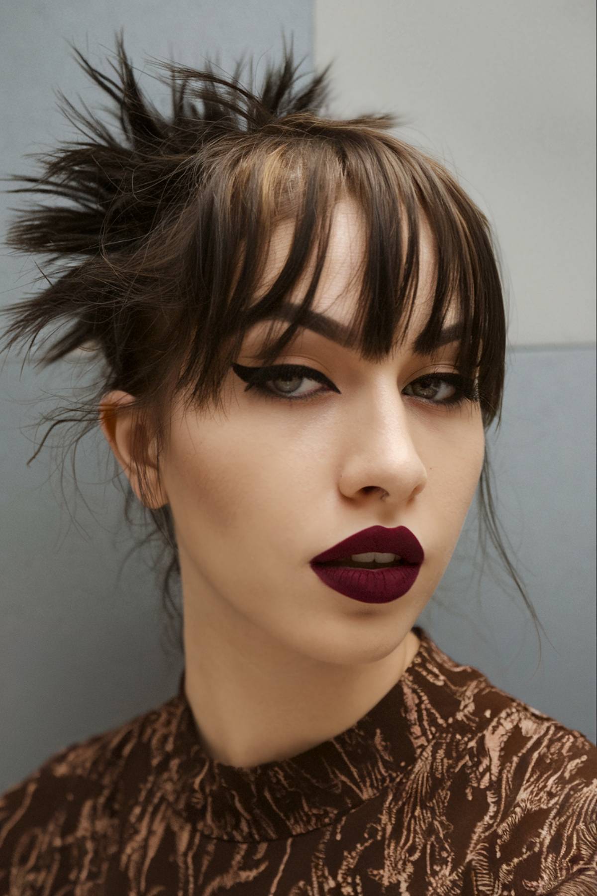 Messy spiked emo updo with choppy bangs and dark brown base