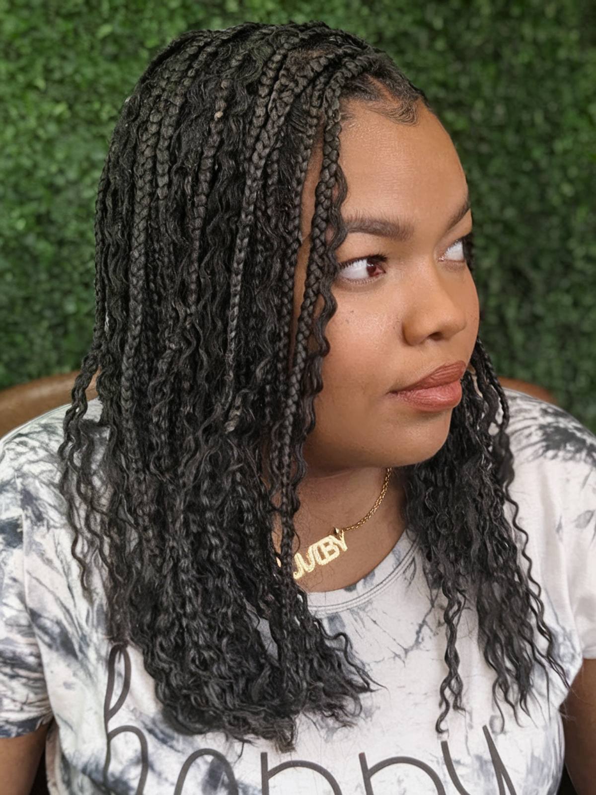 Shoulder-length box braids with rich brown French curls