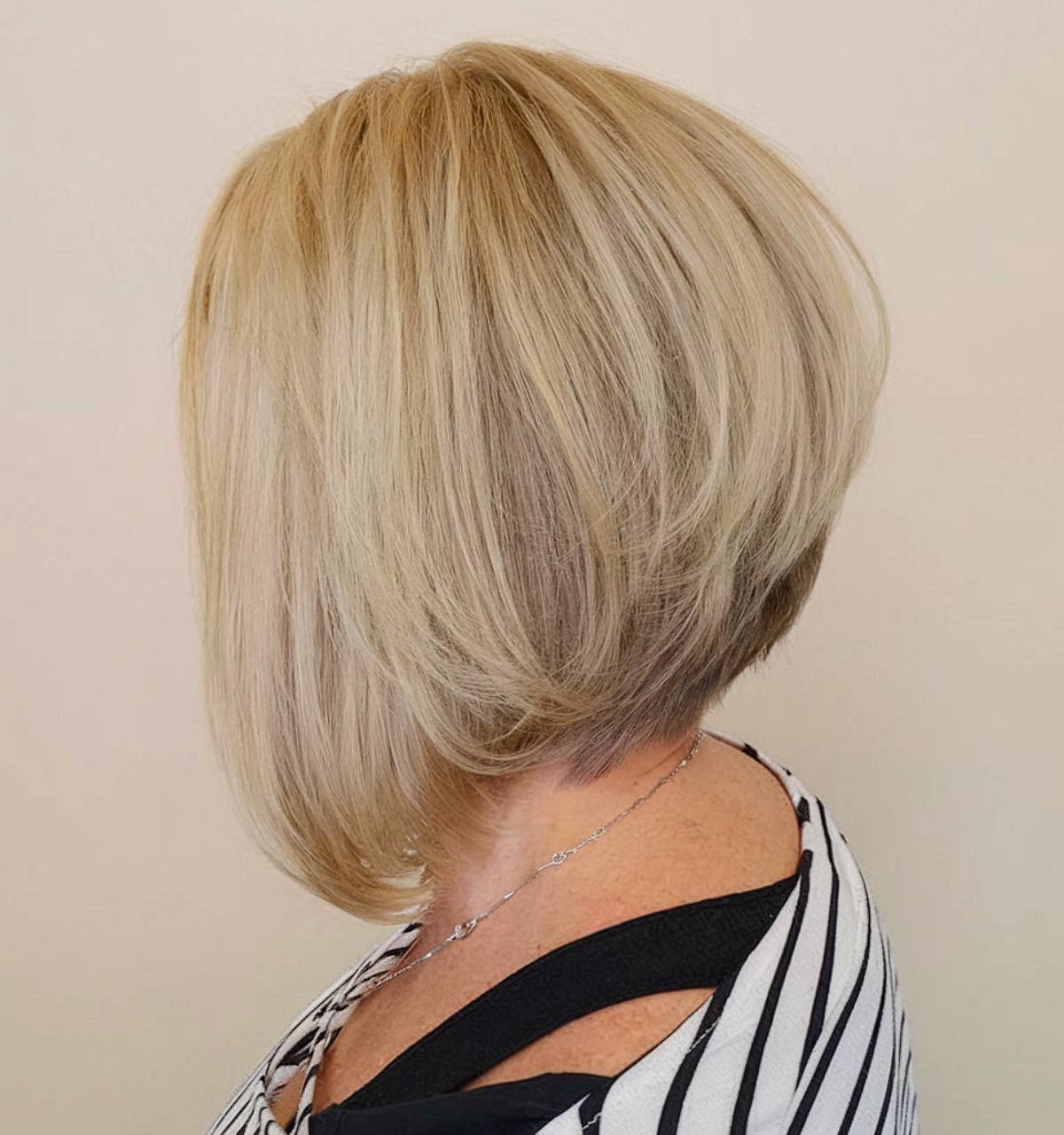 Angled bob haircut for women over 50 with stacked layers