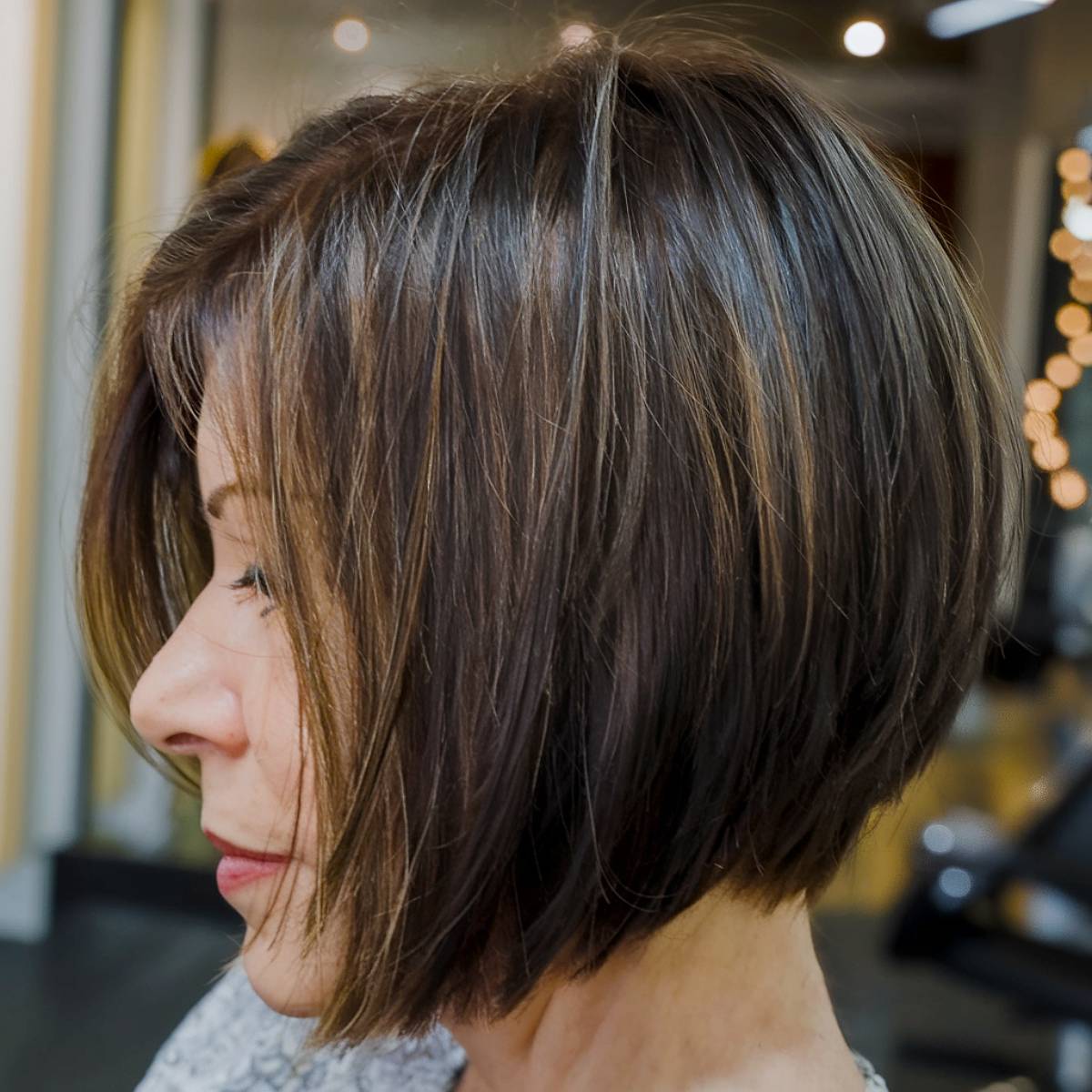 Chin-length angled bob with subtle layers for a classic and refined style, great for older women