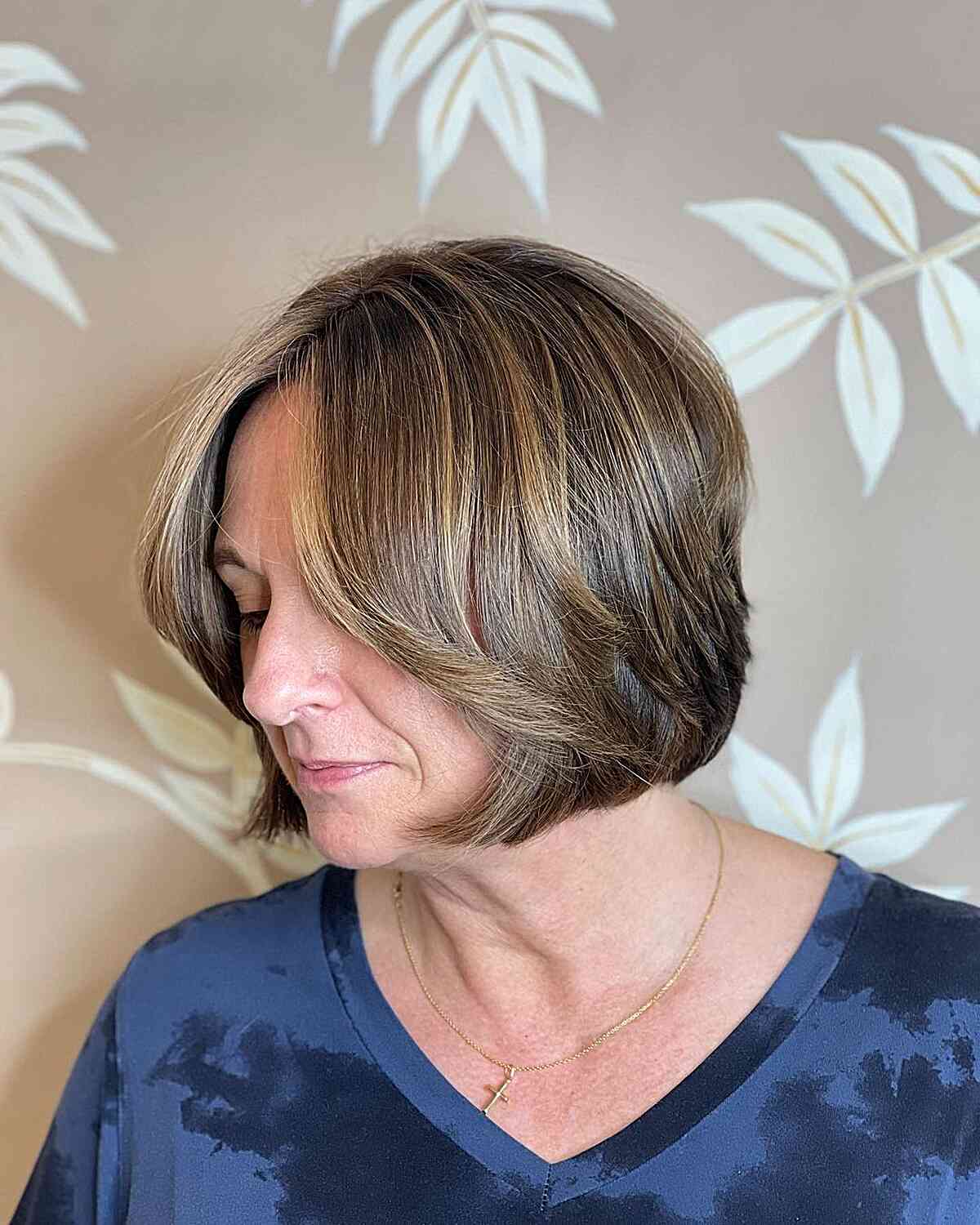 Chin-Length Brown Bixie with Subtle Blonde Highlights for Mature Women