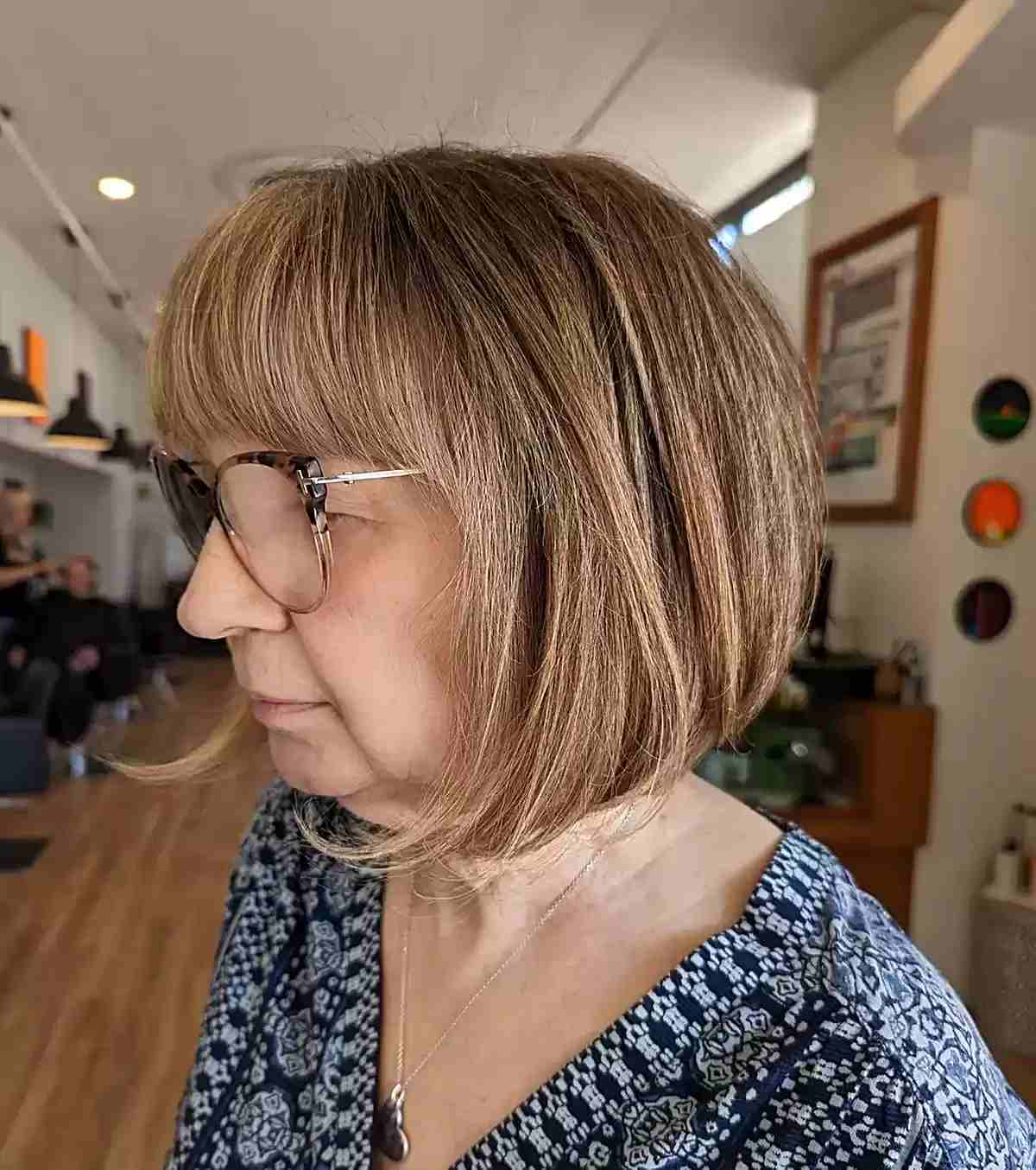 Chin-Length Brown Rounded Bob with Full Bangs for 60-Year-Old Women