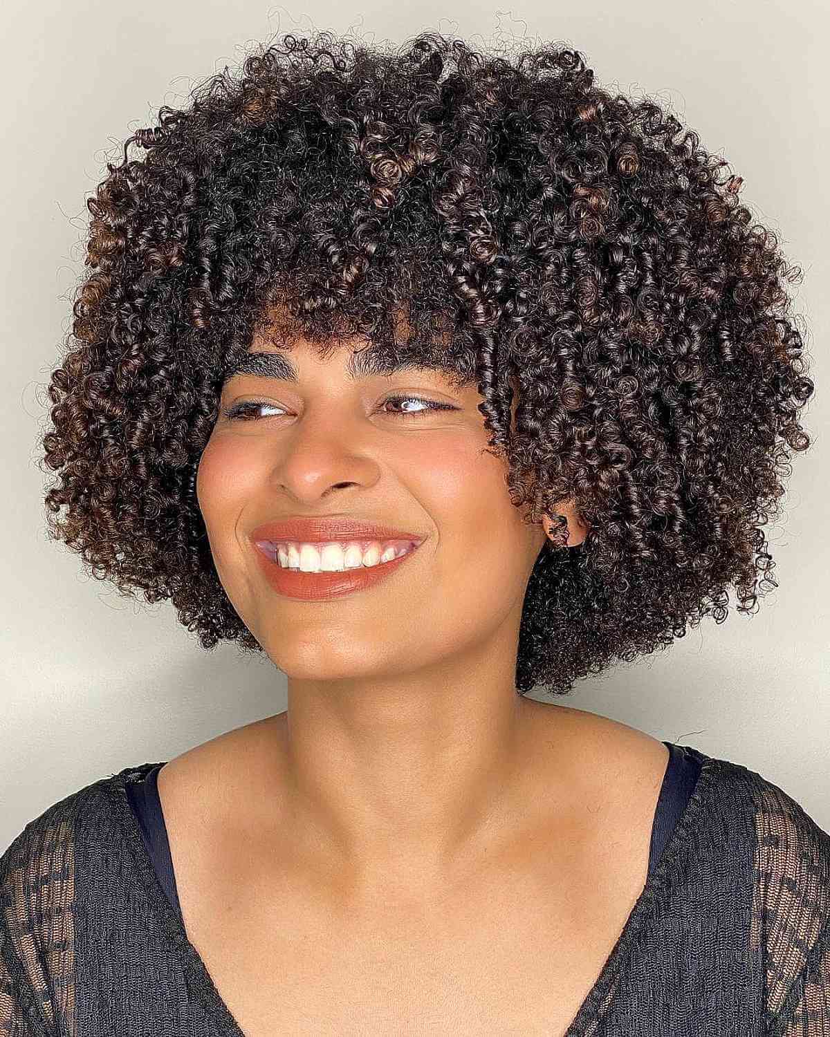 Chin-Length Short Fluffy Haircut with Bangs for Coils