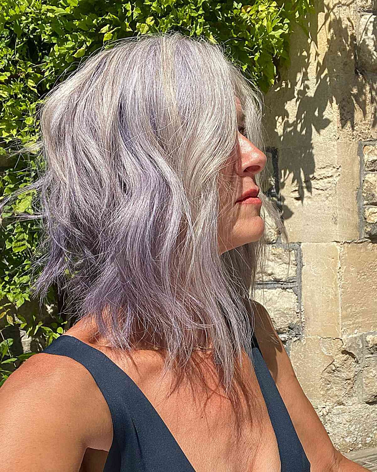 Choppy Collarbone-length Angled Wavy Bob With Purple Highlights on Silver Hair