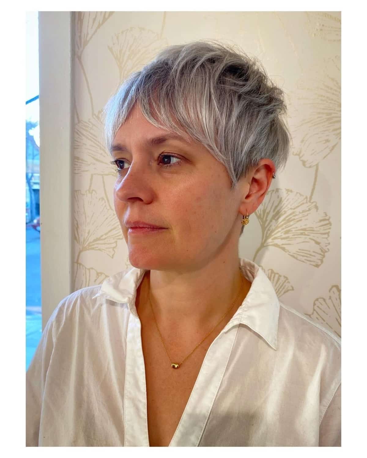Natural-Looking Choppy gray pixie cut with long bangs for 50-year-olds