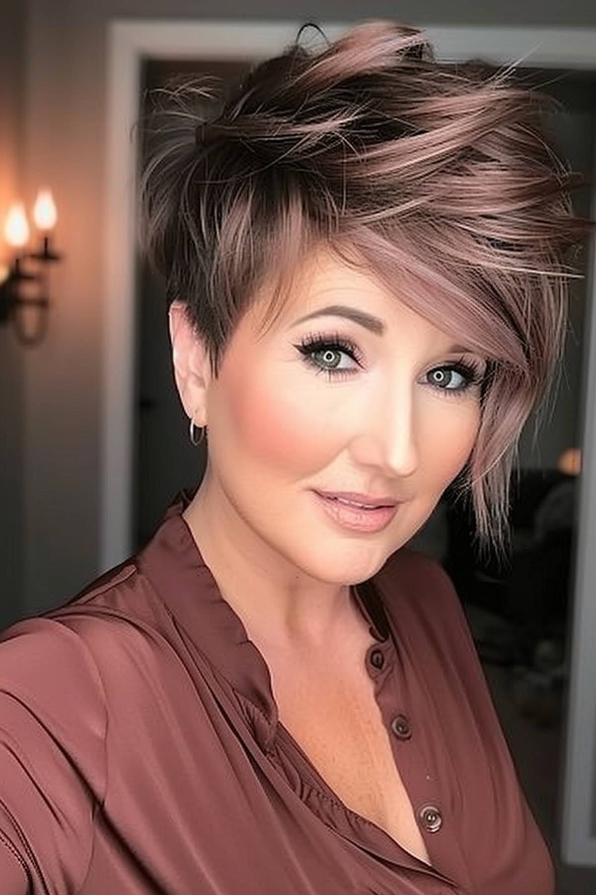 A woman with a diagonal pixie cut and irregular layers gives the hairstyle depth, volume and texture.