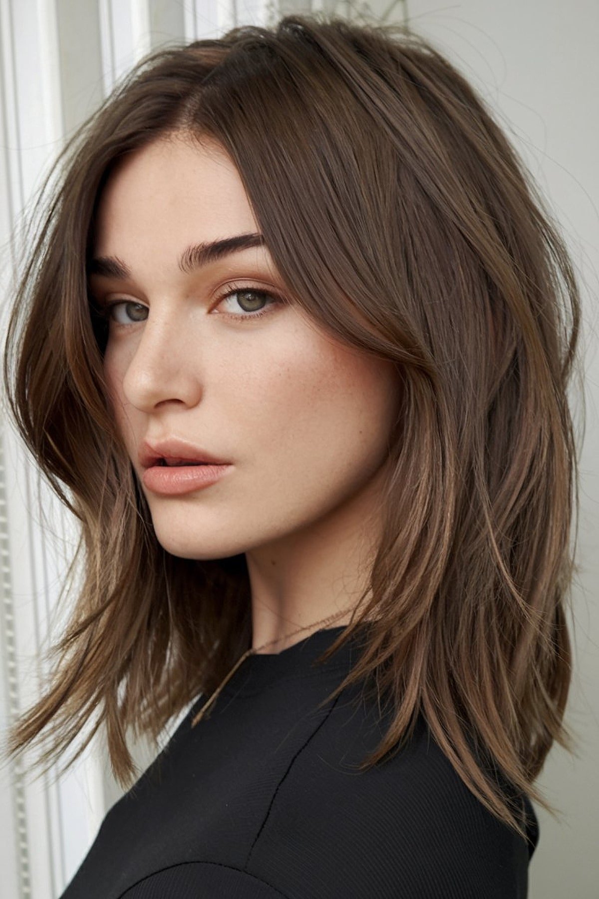 Medium-length haircut with choppy layers for texture and movement