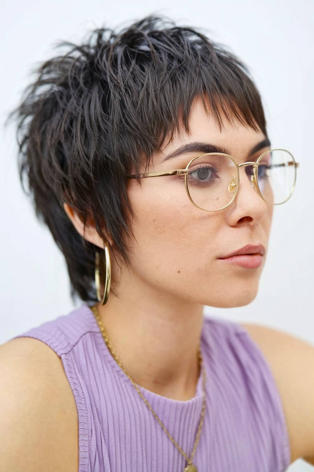 Choppy pixie mullet with edgy texture, featuring jagged layers and a short, piece-y fringe