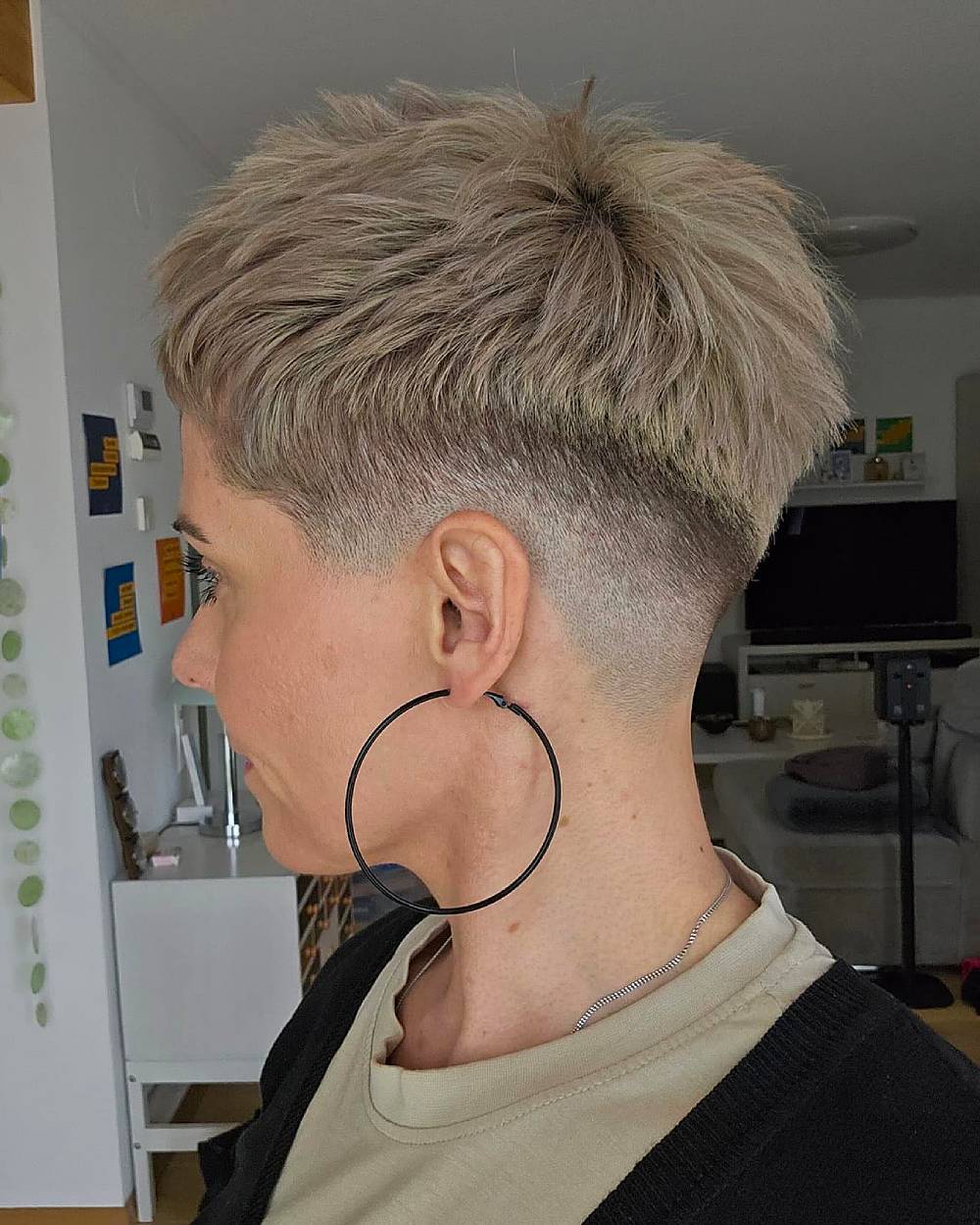 Choppy pixie haircut with tapered sides for short blonde hair