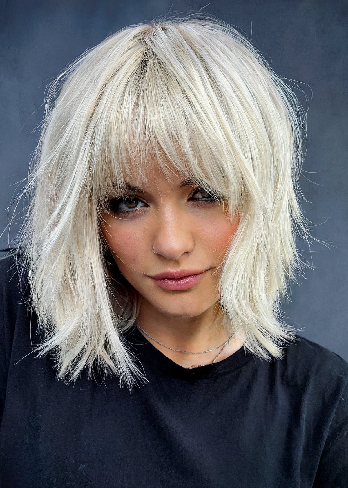 Choppy platinum blonde shag bob with wispy bangs hairstyle