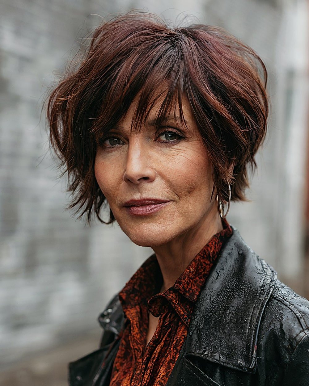 Choppy layered haircut with side part and textured bangs for older women