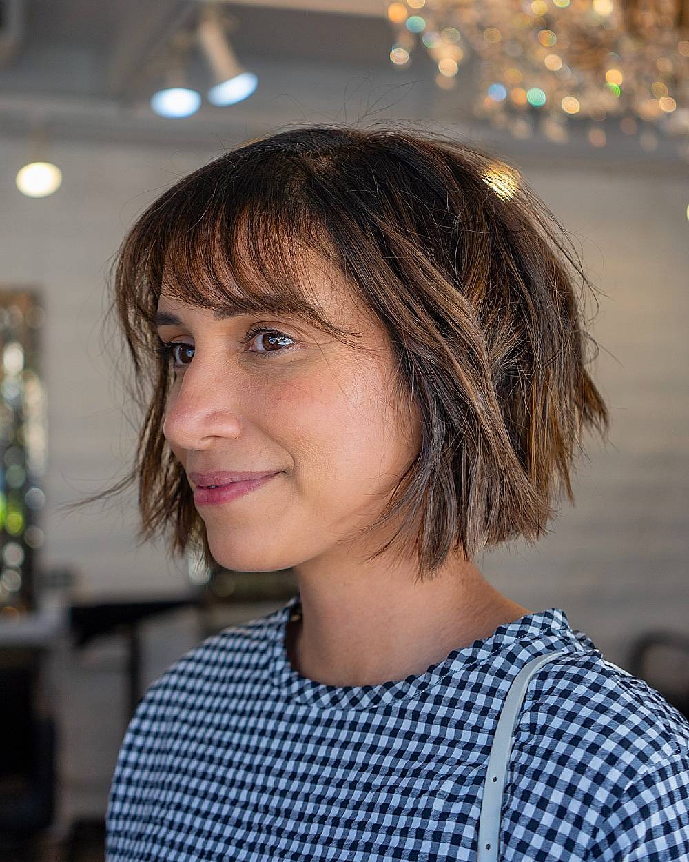 Choppy textured bob with wispy bangs, a tousled short haircut for fine to medium straight or wavy hair