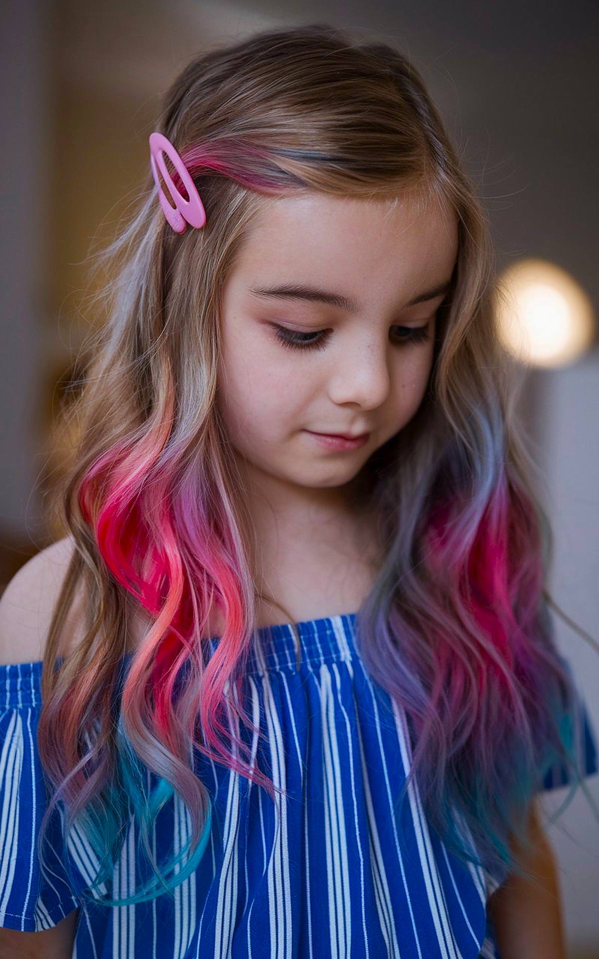 Christmas hair color idea for kids with pink, purple, and blue streaks