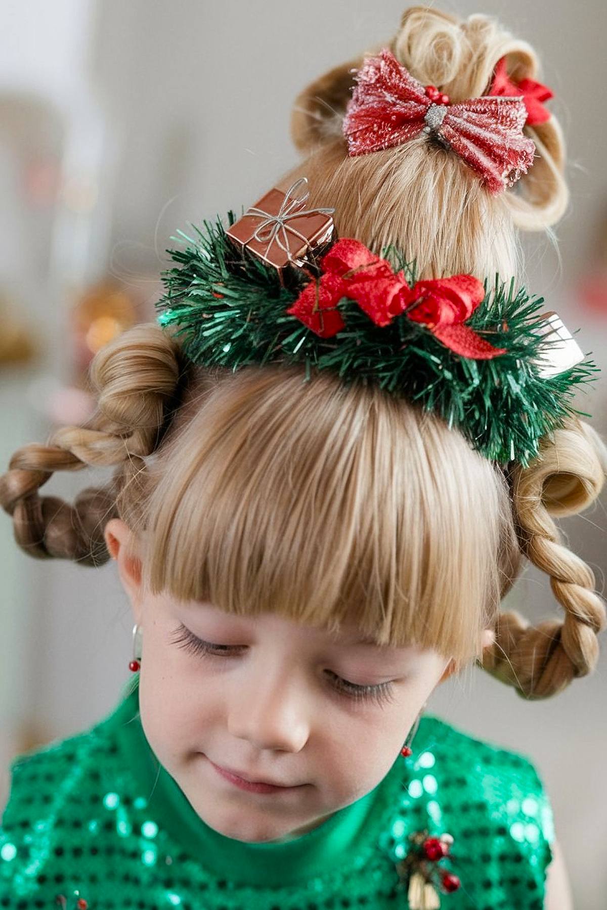 Christmas tree-shaped updo with tinsel, bows, and ornaments for a fun and festive holiday hairstyle