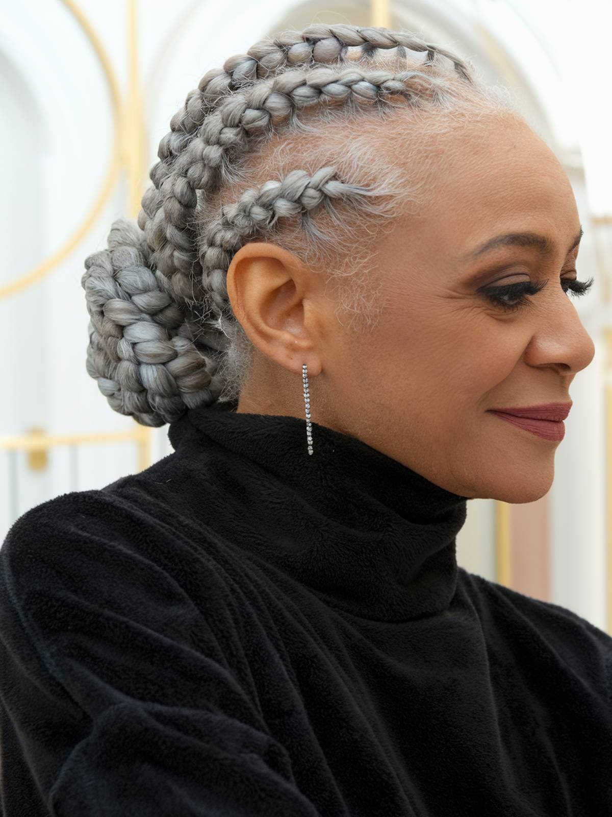 Cornrows with low braided bun for Black women over 60