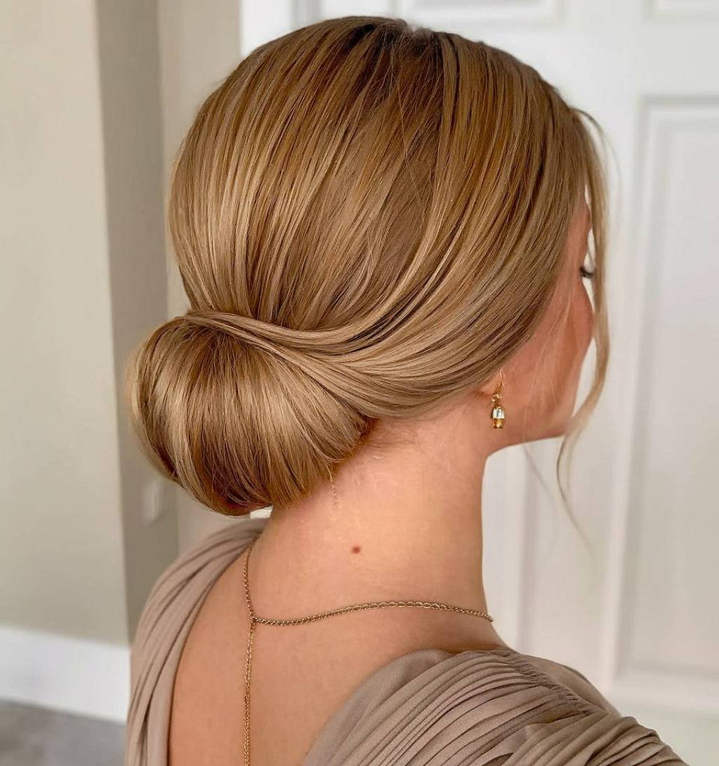 Smooth low chignon prom updo with soft side part