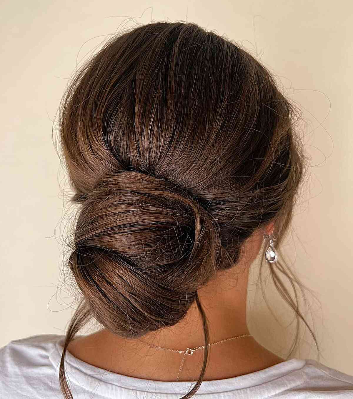 Classic Loose Bun on Brunette Hair with Pulled-Out Strands Easy Updo