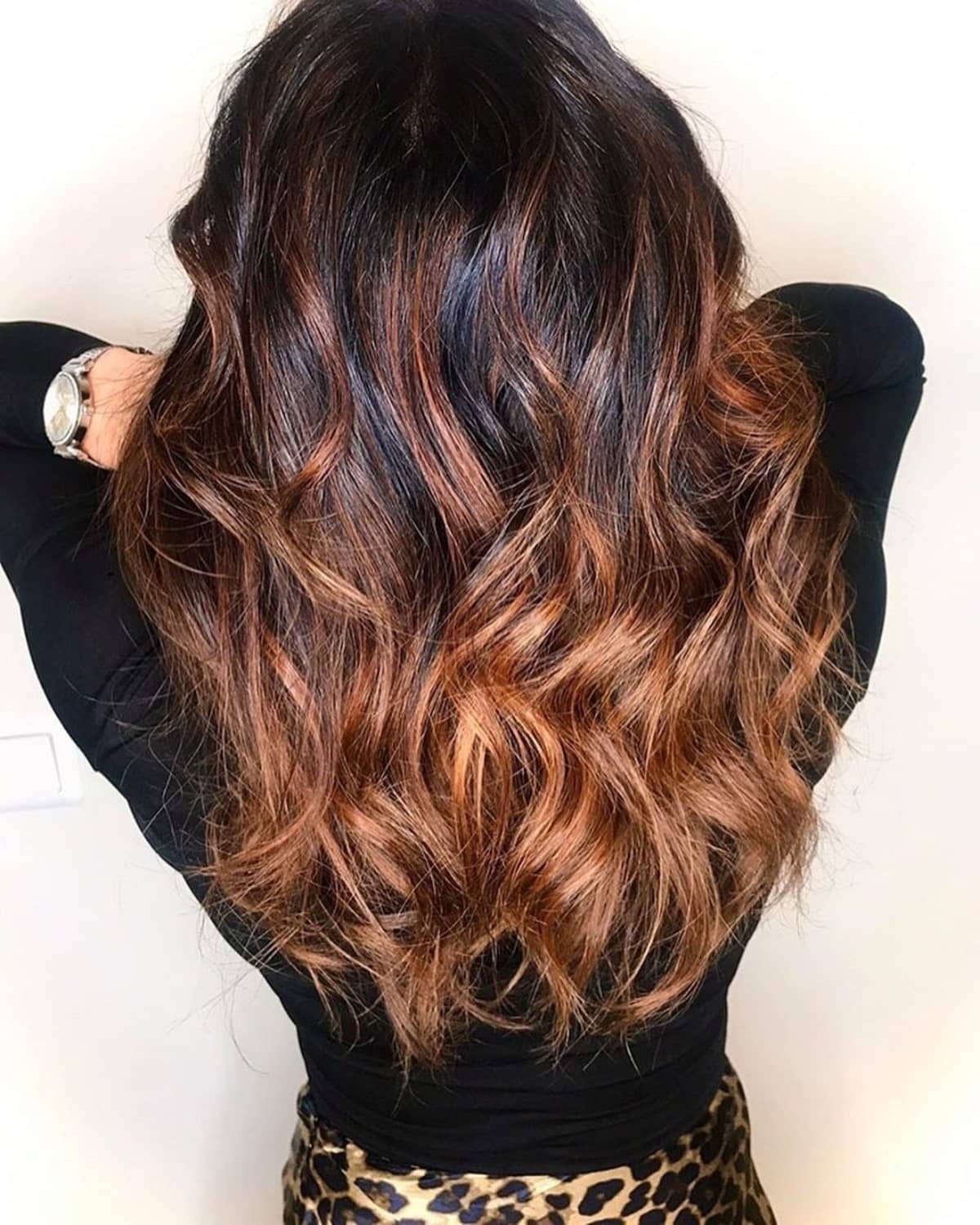 Vibrant copper brown highlights on black hair