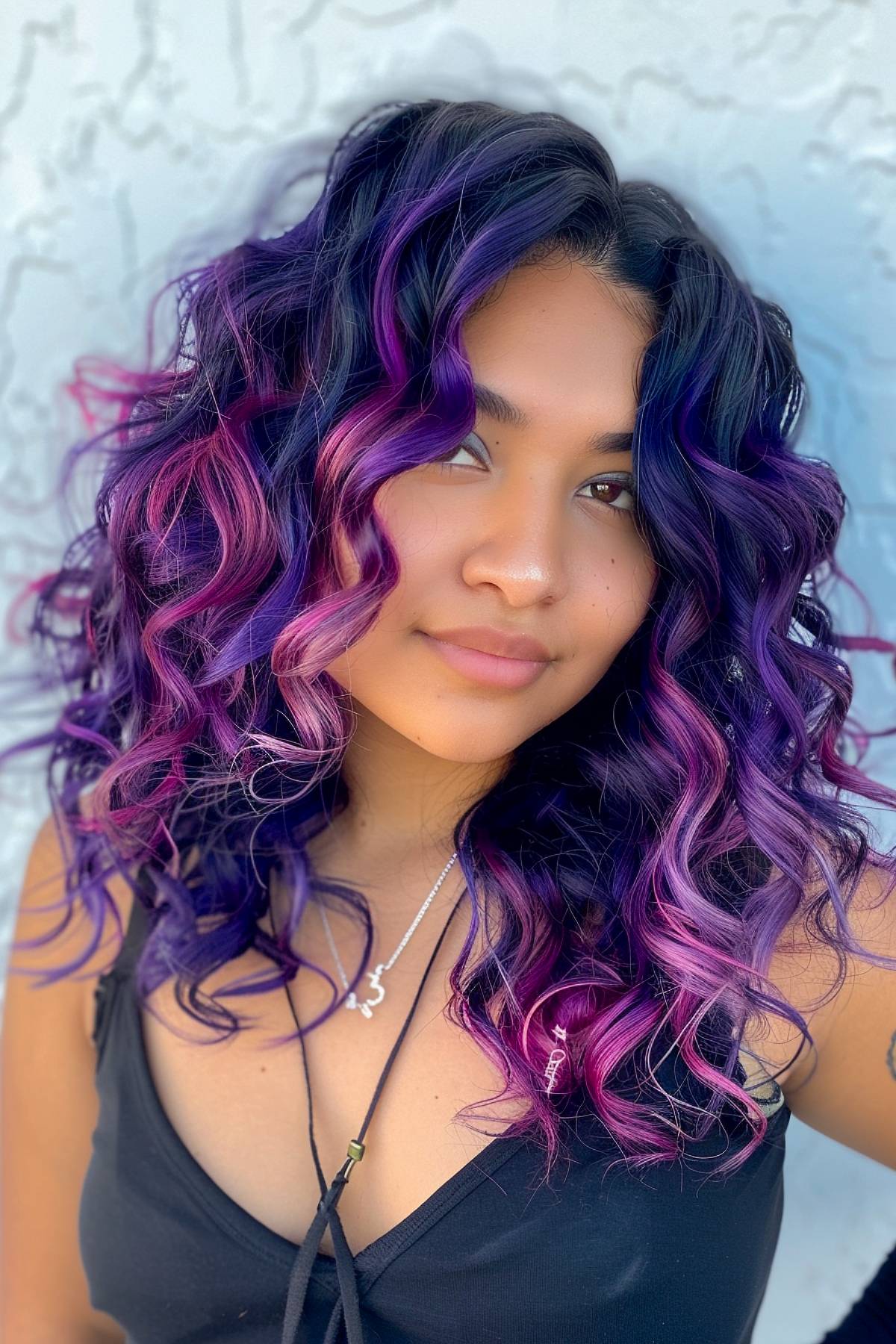 Voluminous curls in vibrant purple and pink tones