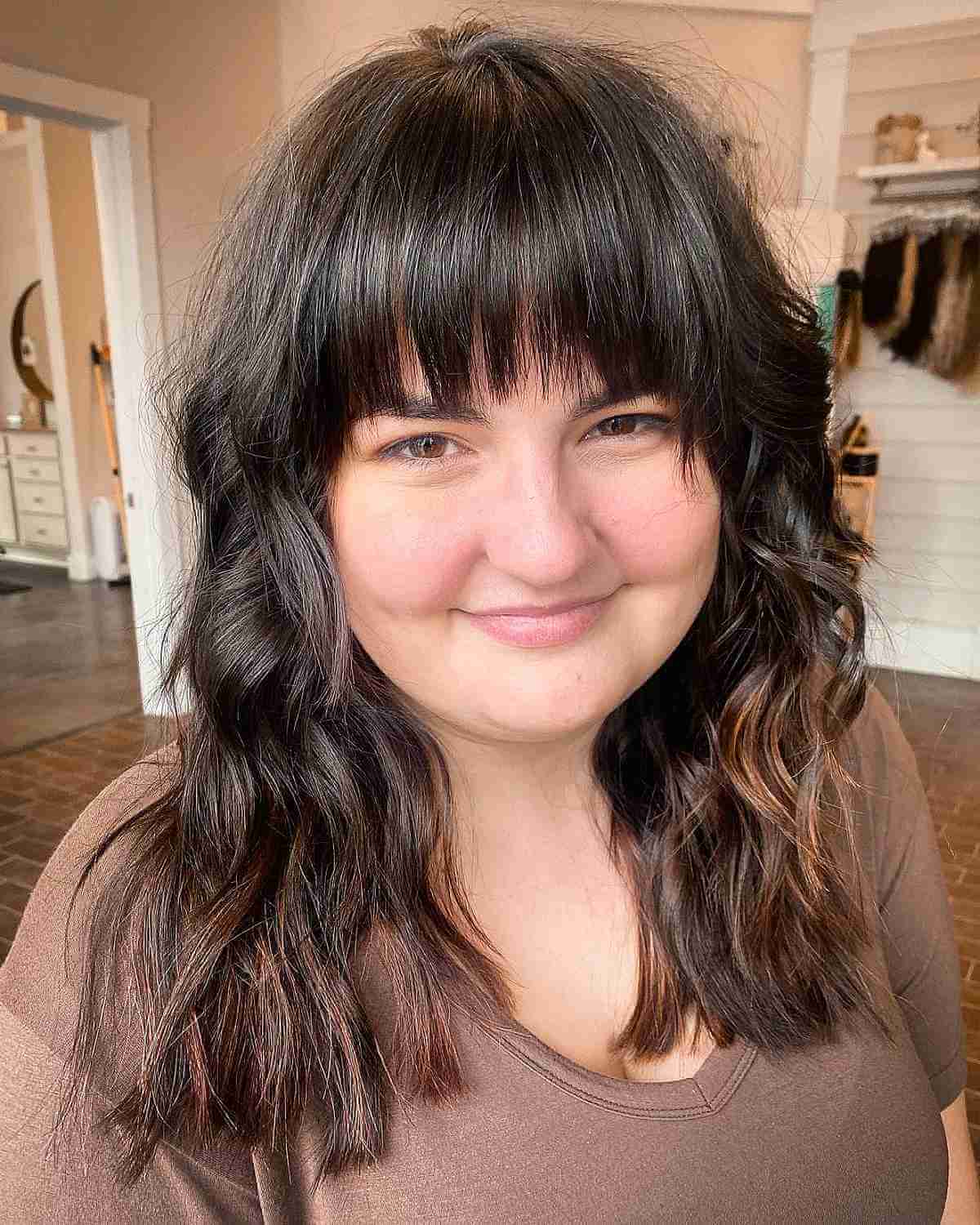 Curled Mid-Length Hair with Straight Bangs for Round Faces