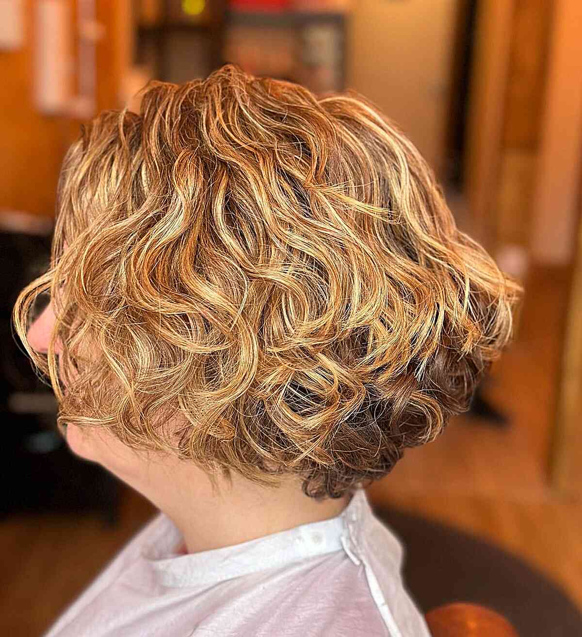 Jaw-Grazing Curly Blonde Bob with Graduation for Older Women's Thick Hair