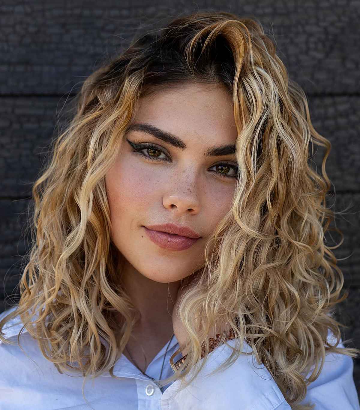 curly blonde hair with dark roots