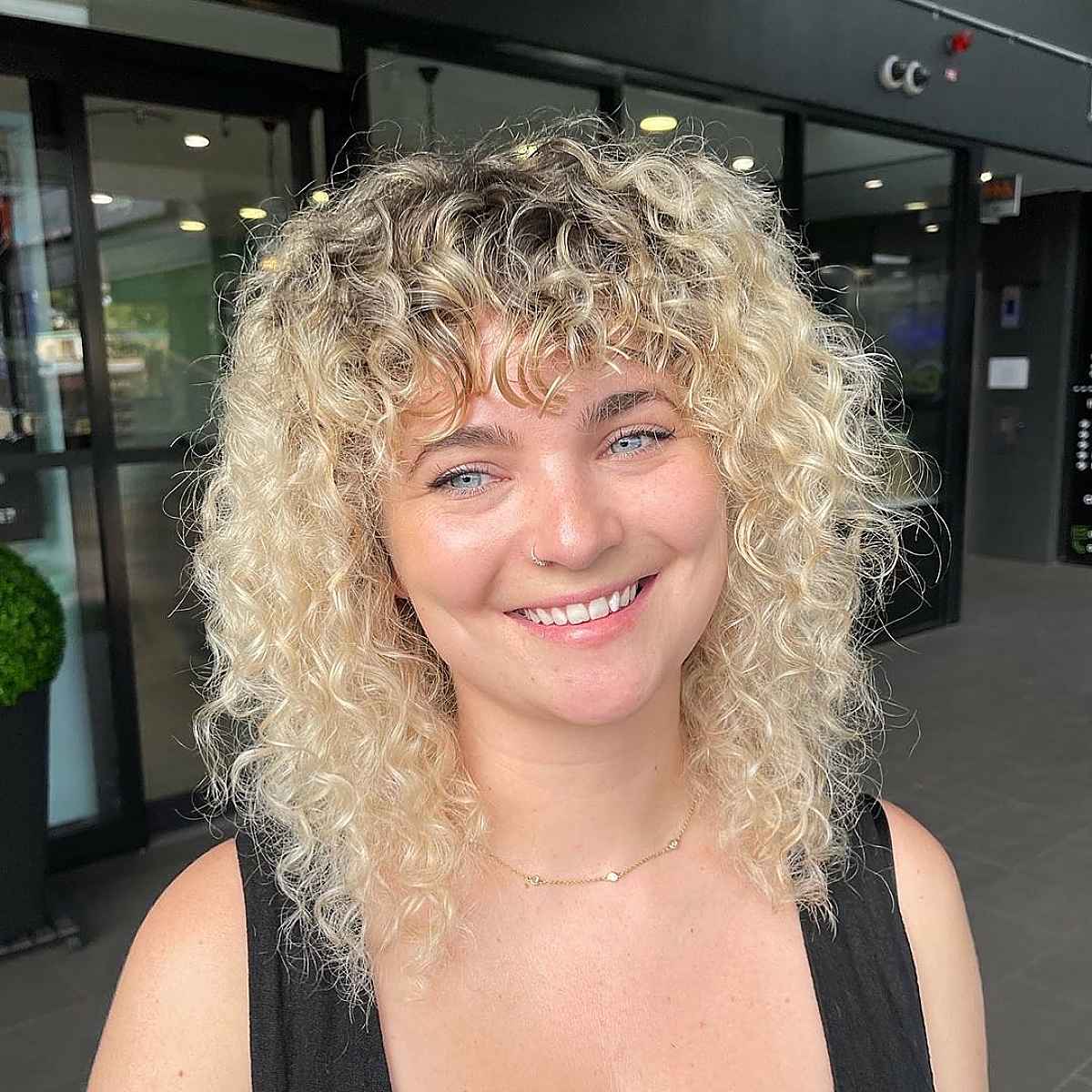 Curly Blonde Shag with Piece-y Bangs