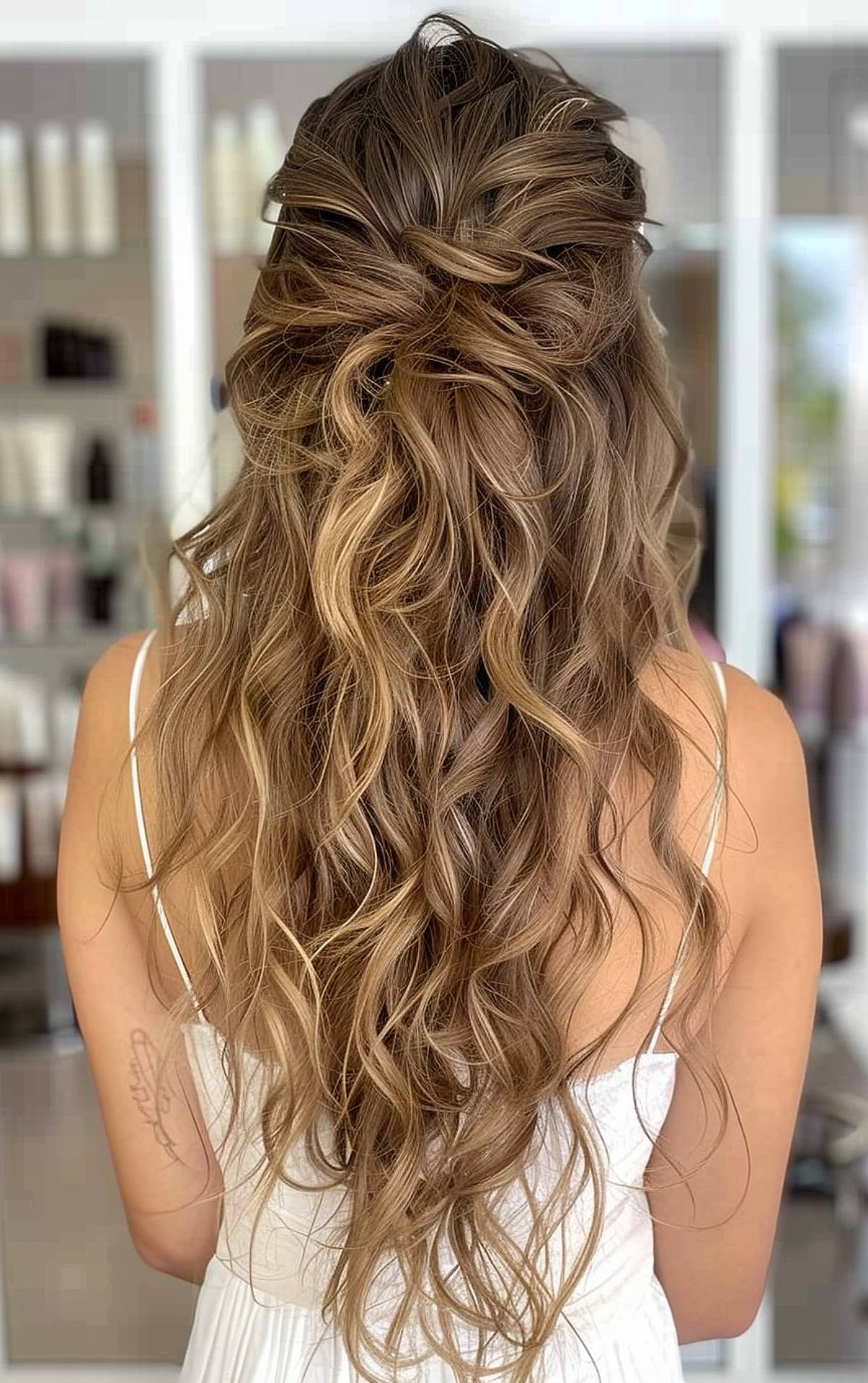 Curly formal hairstyle for long hair with half-up twist and loose waves