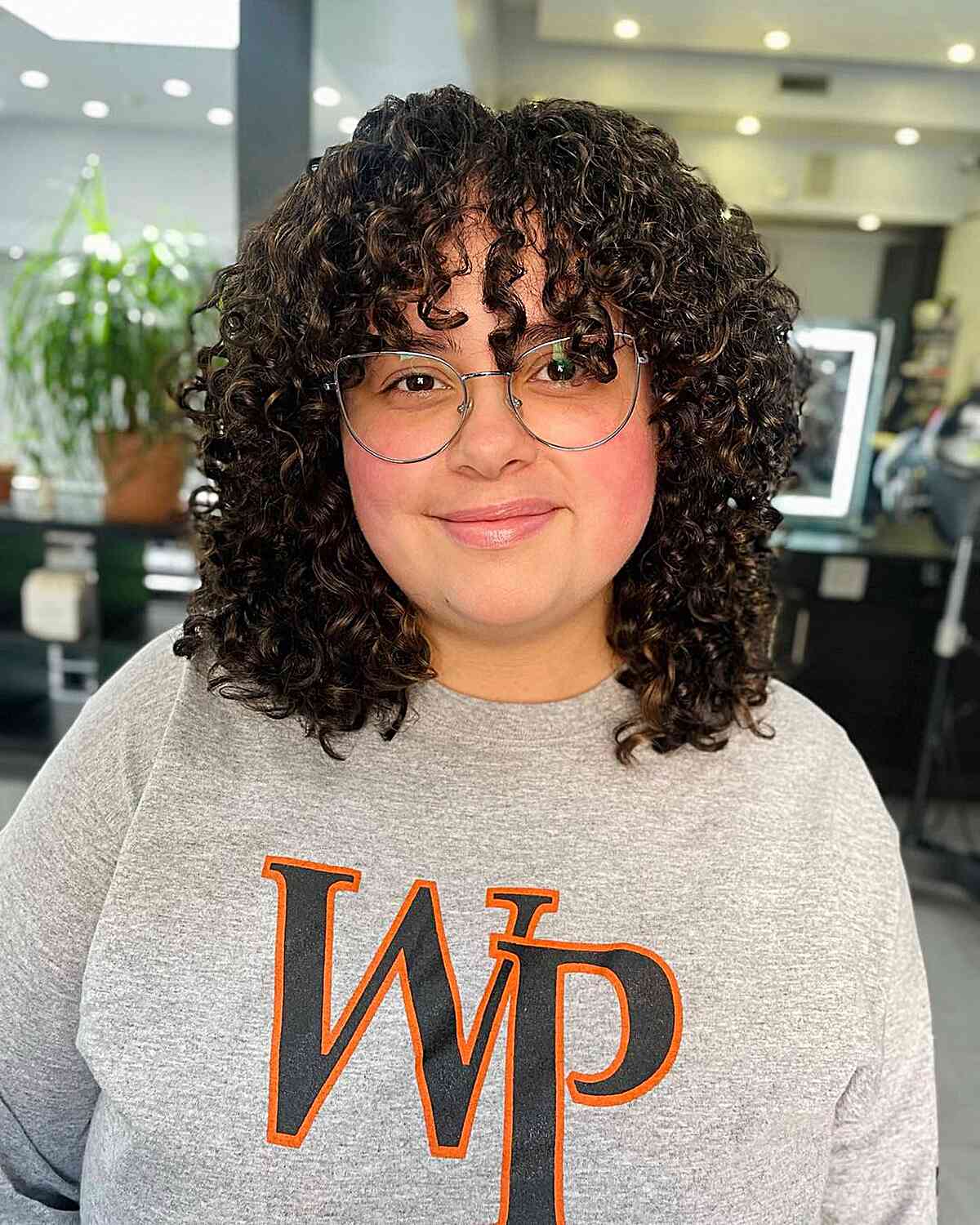 Curly Fringe on a Curly Cut for Full-Faced Women with glasses 