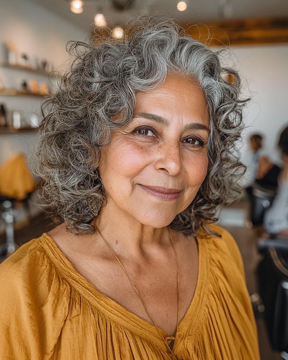 Curly hair with tousled layers for older women and natural gray blend