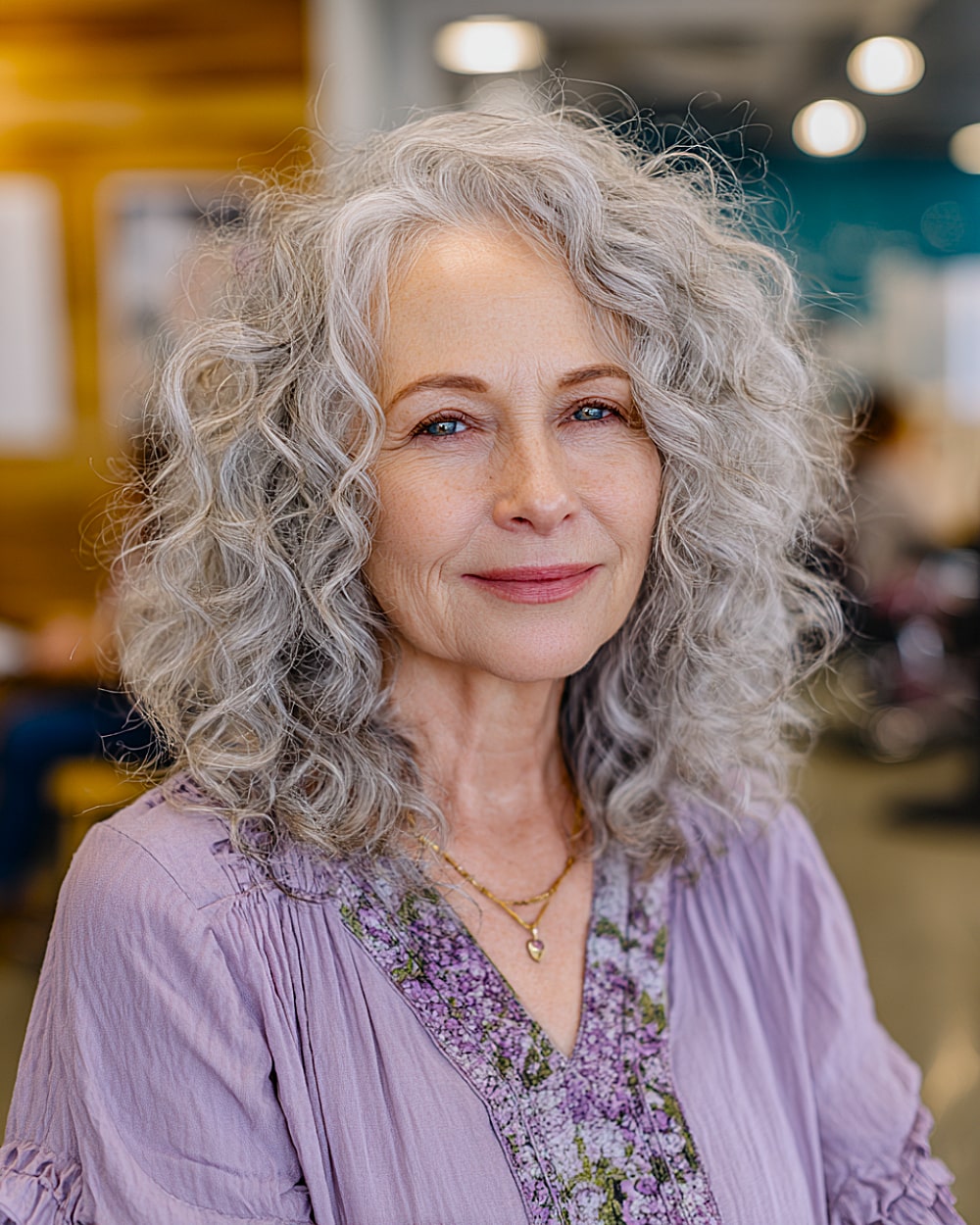 Soft gray curly hairstyle for older women with layered cut and gentle volume