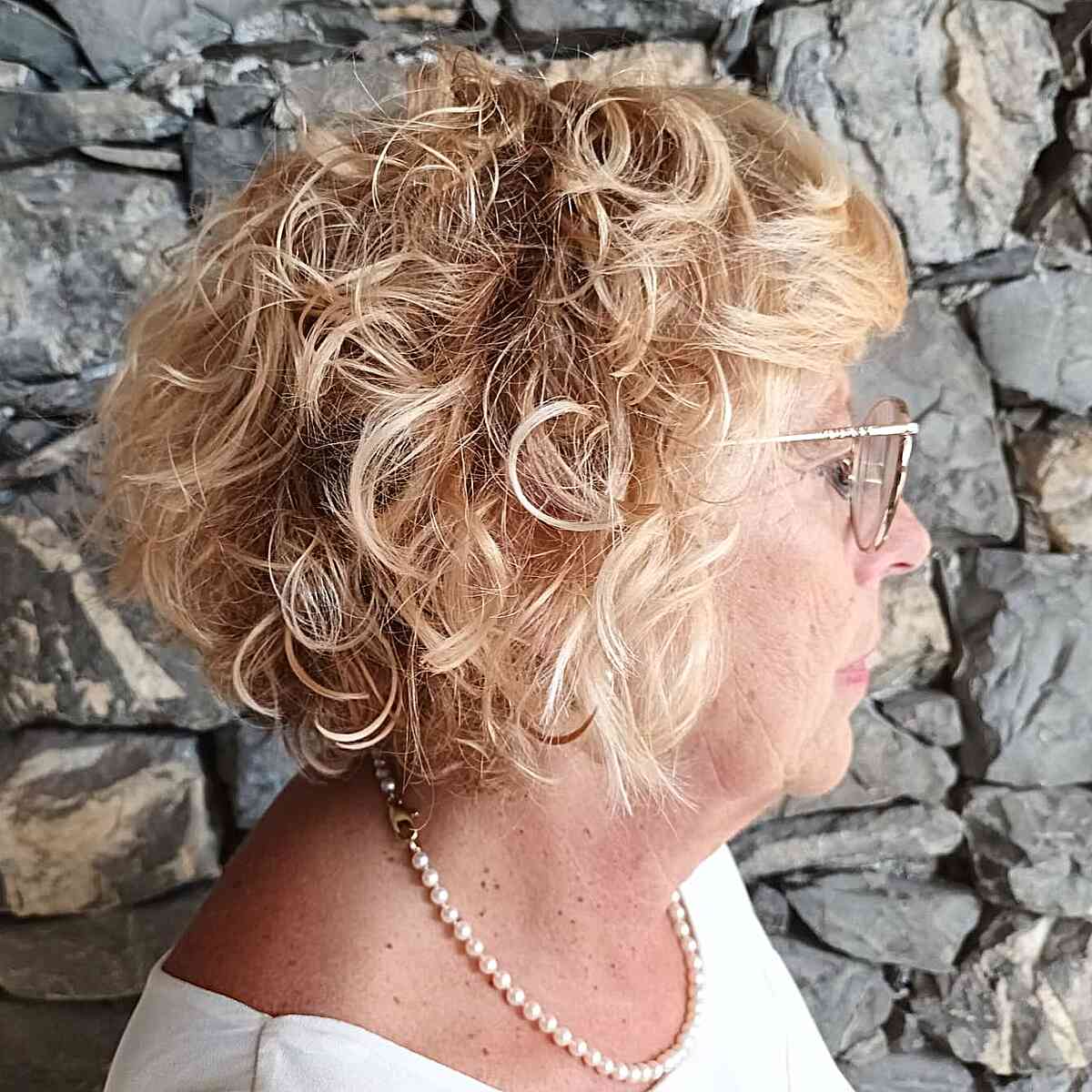 Jaw-Length Curly Inverted Bob with Bangs for Wash and Wear Women Over Fifty with Blonde Hair