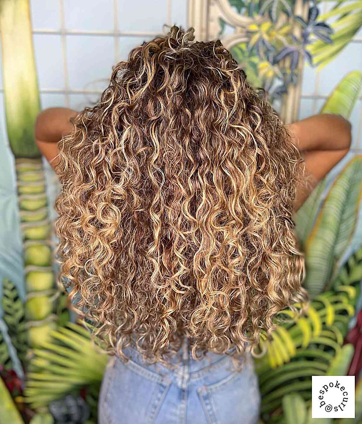 Curly Light Brown Hair with Subtle Blonde Highlights